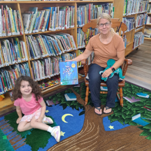 Claire Steeves with child at Story Hour